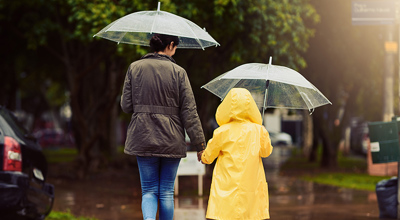 Mother Child Umbrellas Rain Hurricane Helene SALT Relief