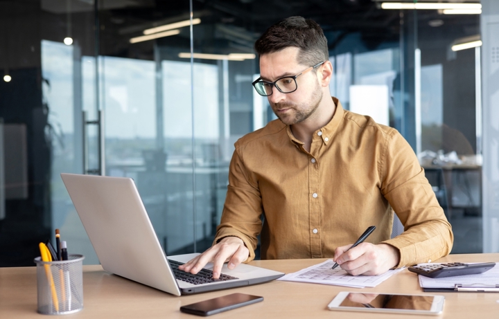 Man Monitoring Contracts On Computer