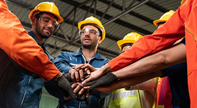 Construction Workers Circle Hands In Mental Health